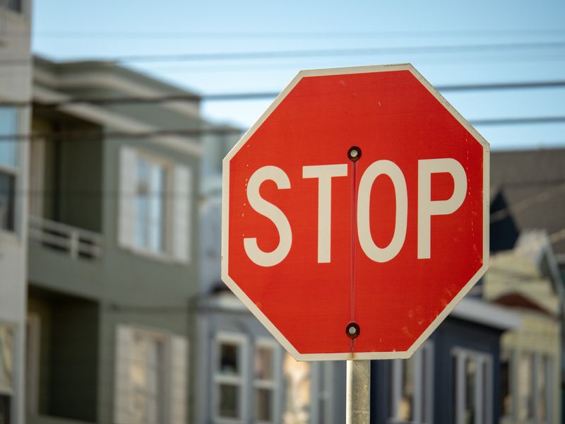 A red stop sign in a residential neighborhood
