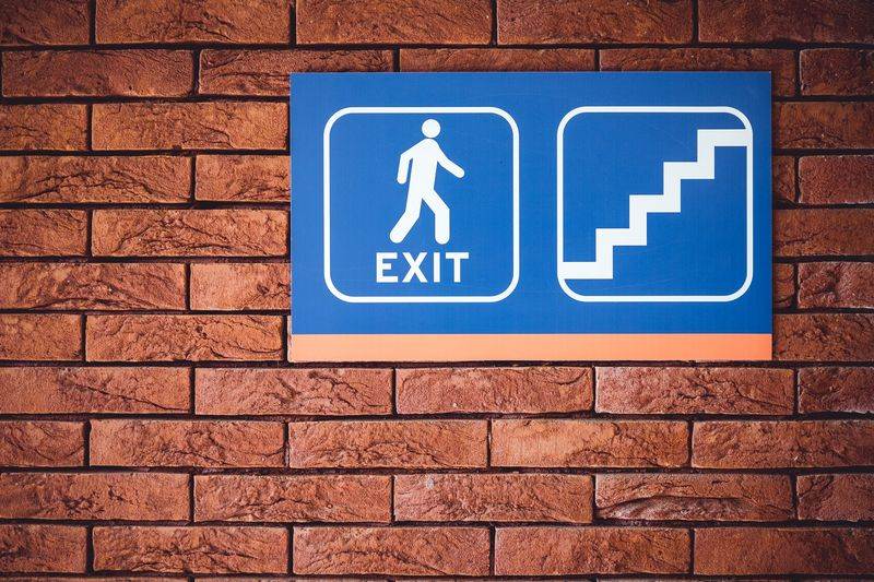 A custom road sign showing where pedestrians can exit using stairs
