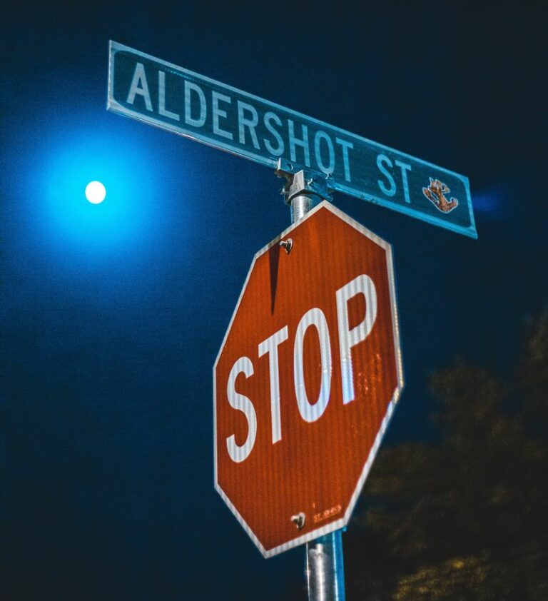 Moon shines over a traffic stop sign