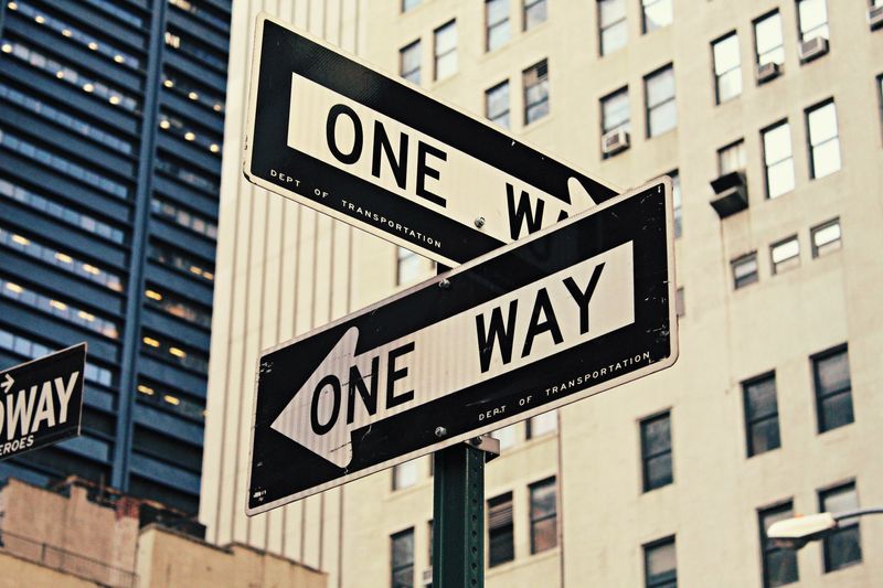 "One Way" sign post