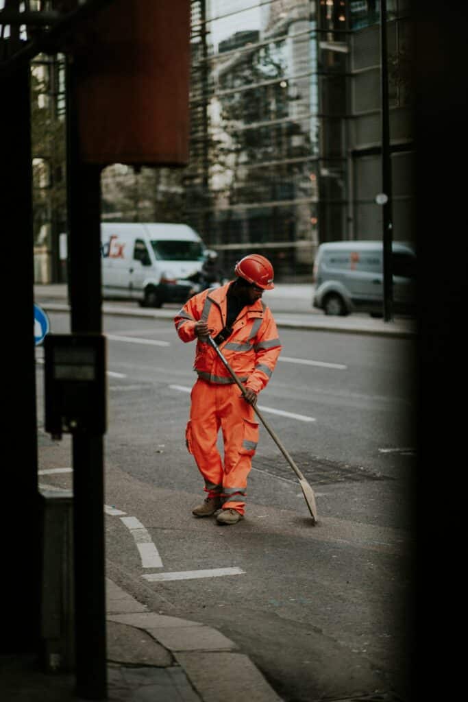 A construction worker wearing traffic safety equipment. https://unsplash.com/photos/0ekKShZDHT8?utm_source=unsplash&utm_medium=referral&utm_content=creditShareLink