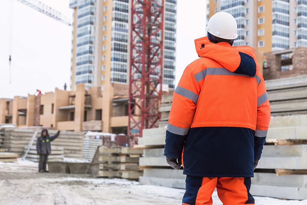  A man standing in cold weather with bright, effective traffic safety equipment in the work area
https://www.shutterstock.com/image-photo/builder-on-construction-winter-uniform-helmet-779841181 