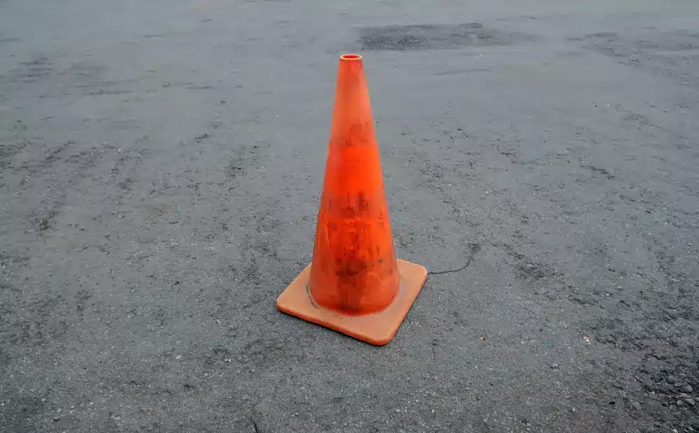 A Slim Profile Traffic Cone on an asphalt road
