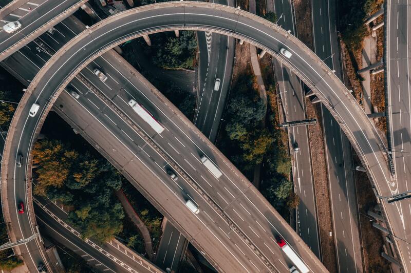 An overhead view of connected vehicles driving on a junction interchange